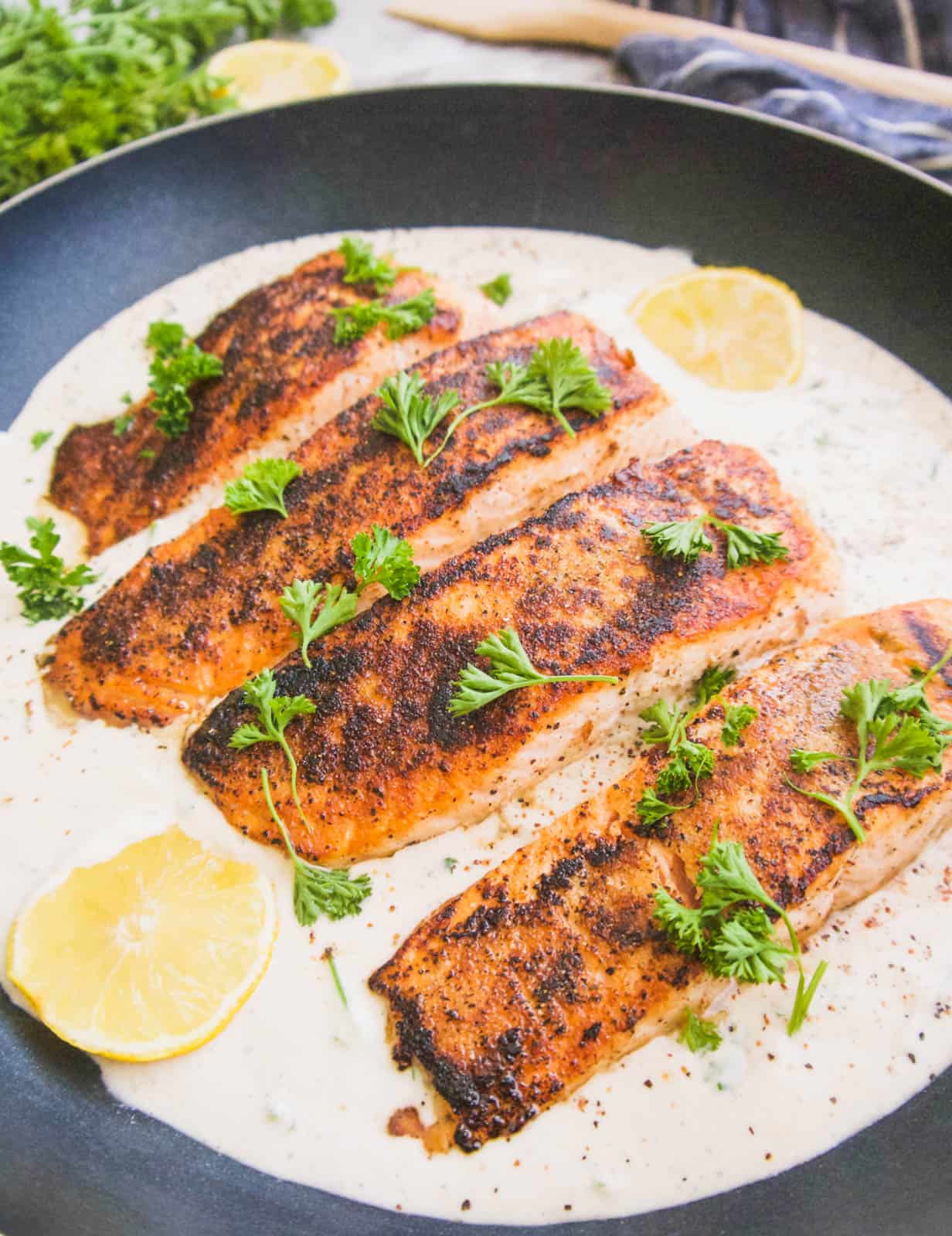 Salmon in a pan with coconut cream sauce.