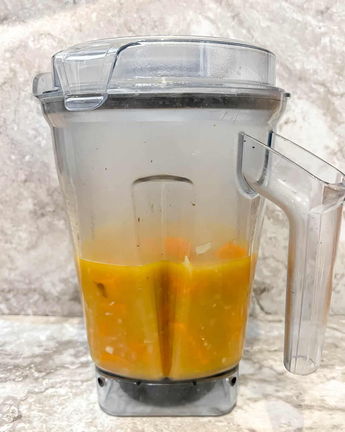 Pumpkin and sweet potato soup in a blender before blending.