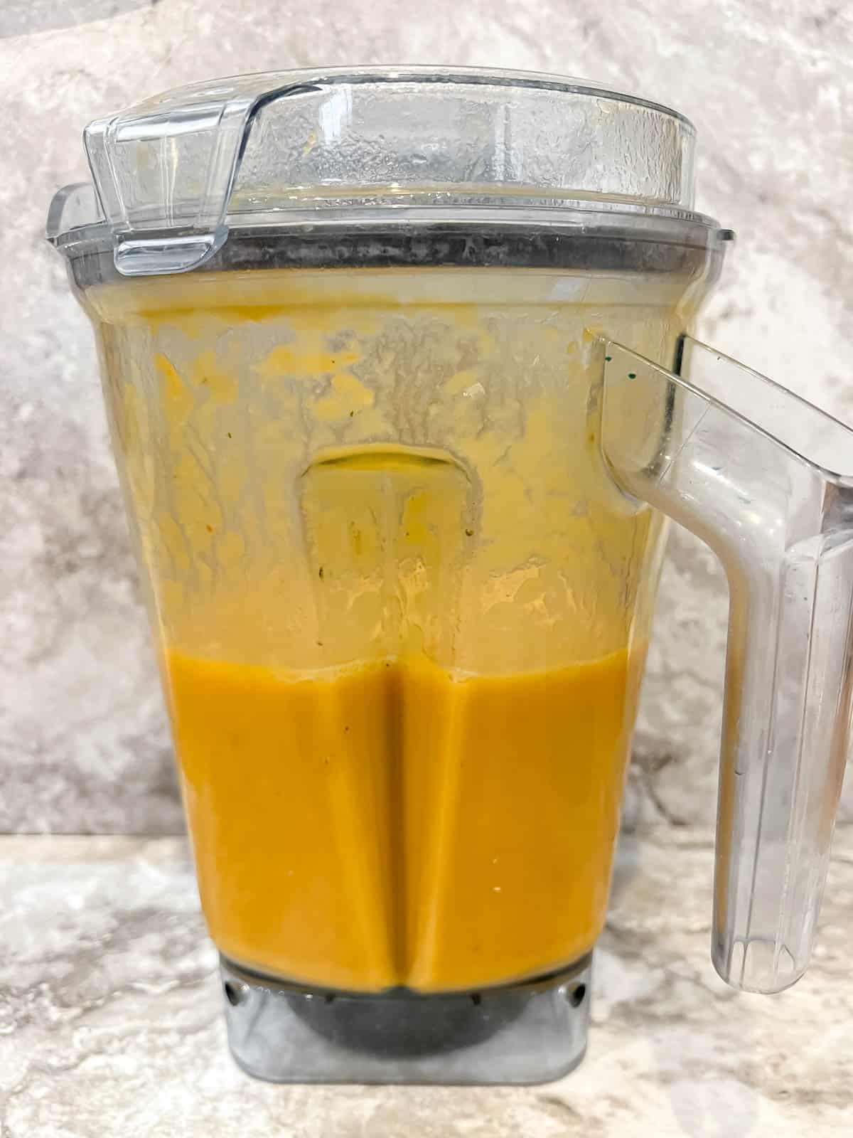 Pumpkin and sweet potato soup in a blender after blending.