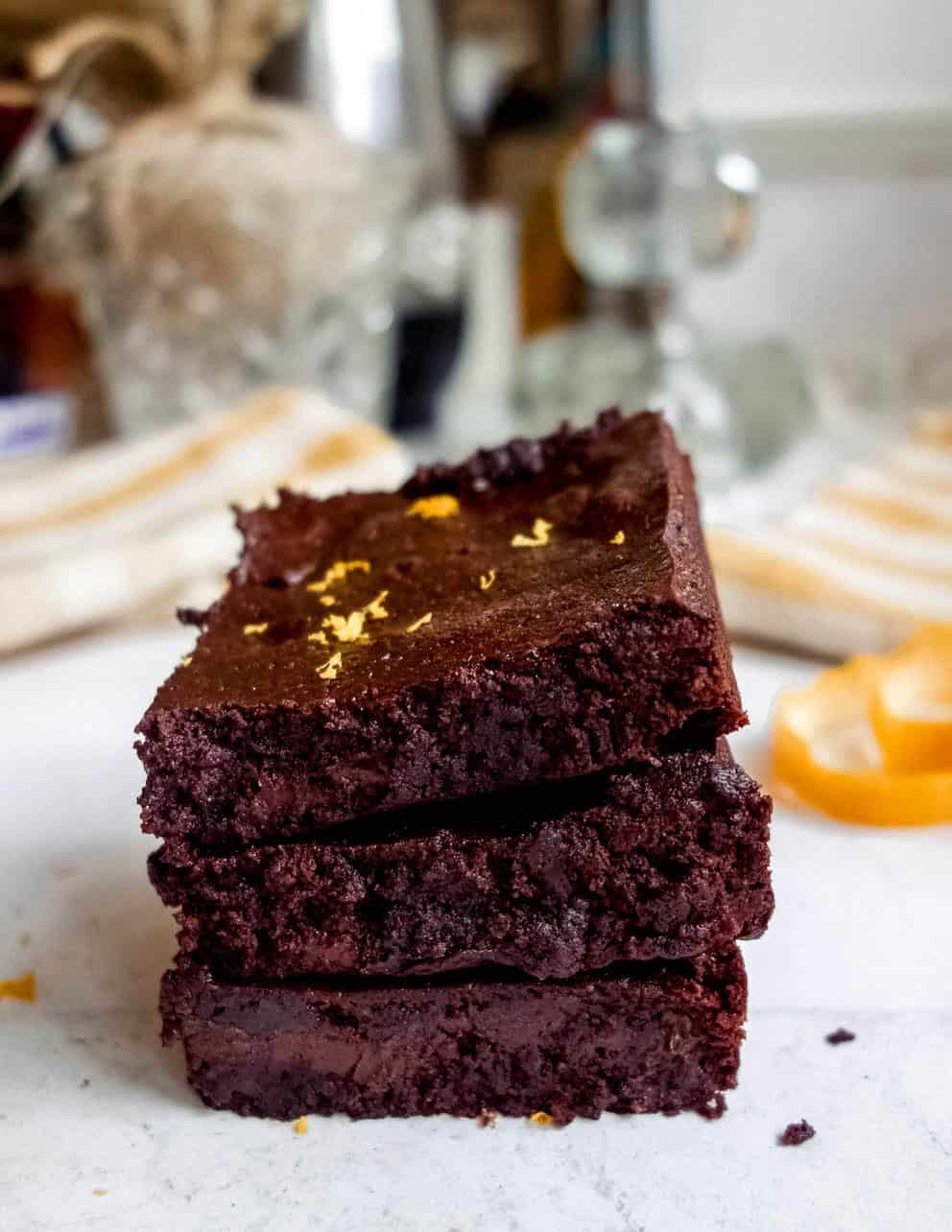 Chocolate Orange Brownies stacked on top of each other. 