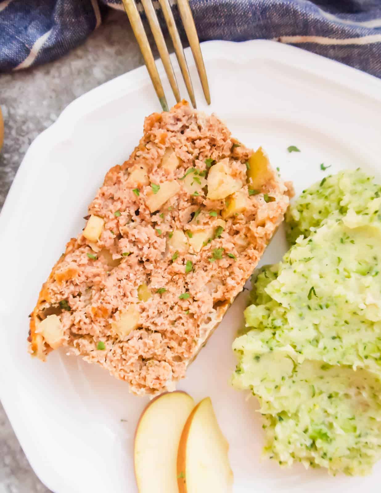 A slice of turkey apple meatloaf on a plate.