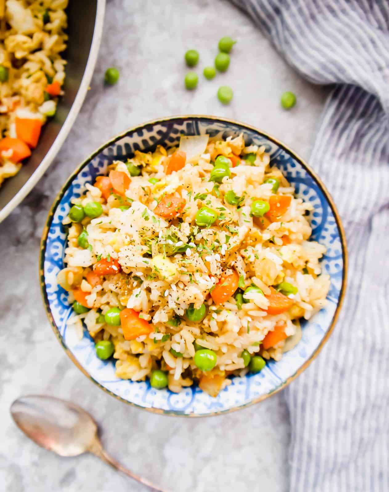 Coconut aminos fried rice in a bowl with sesame seeds on top.