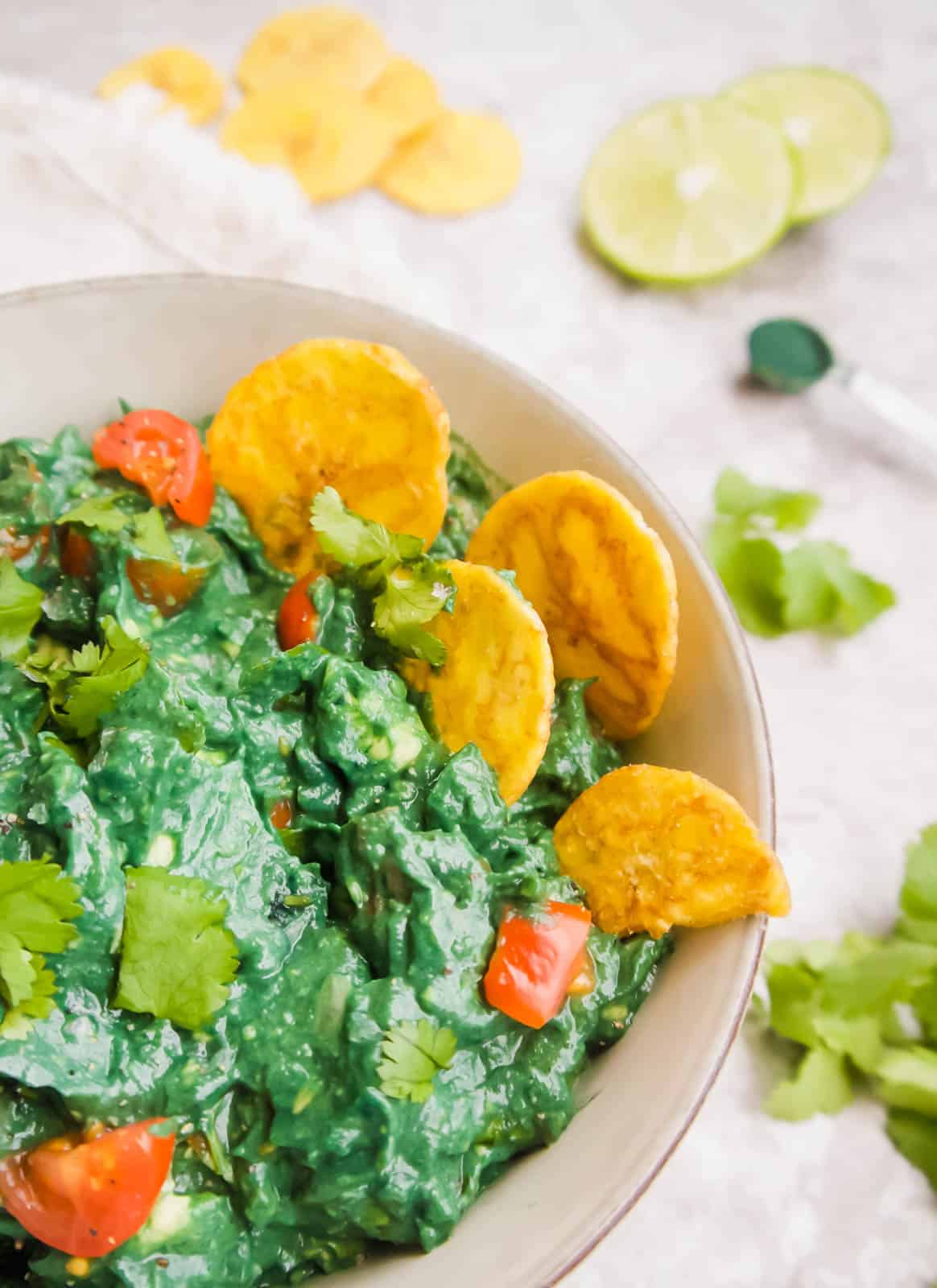 Spirulina Guacamole with plantain chips inside.
