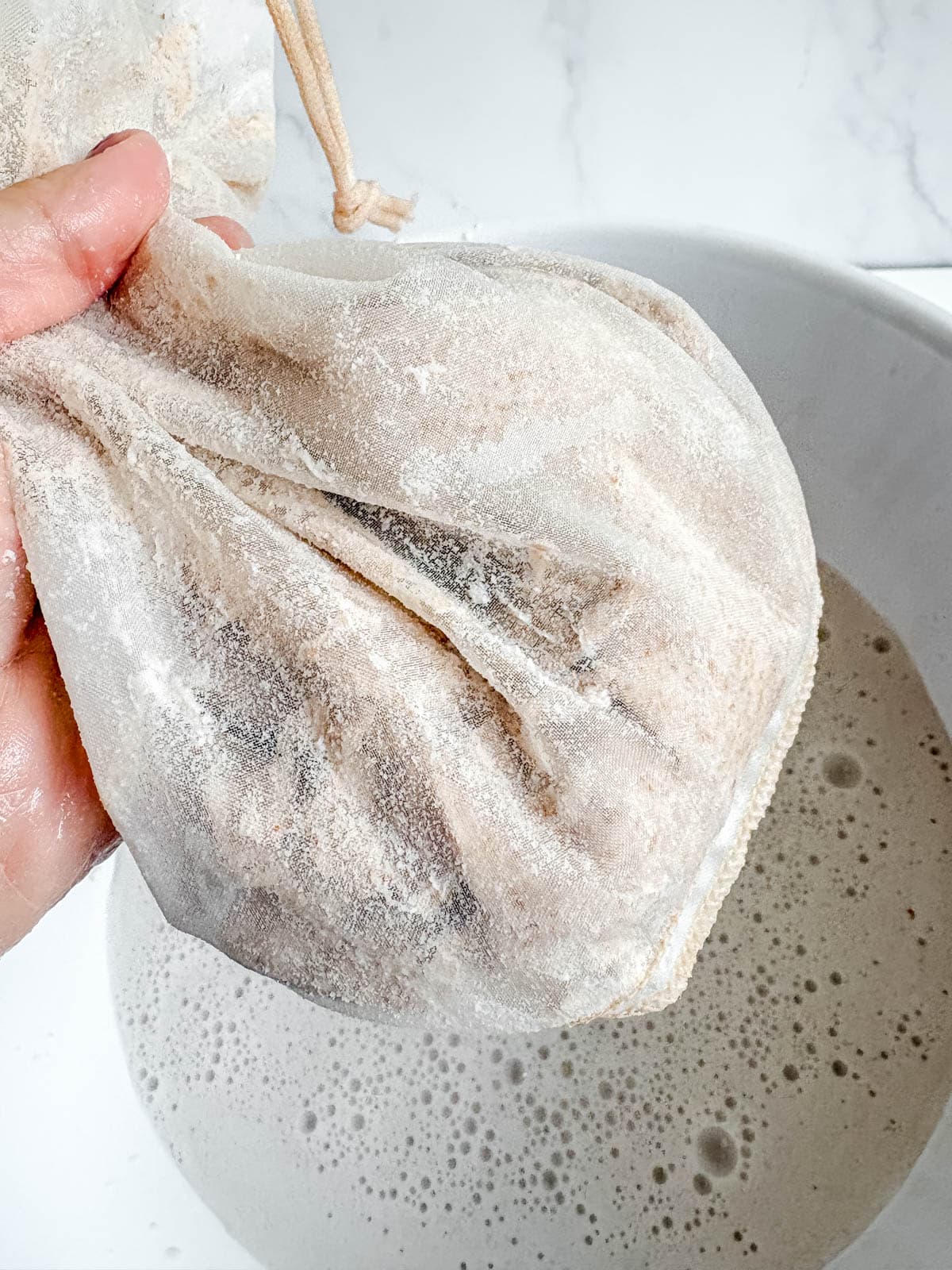Dry almond meal in nut milk bag.