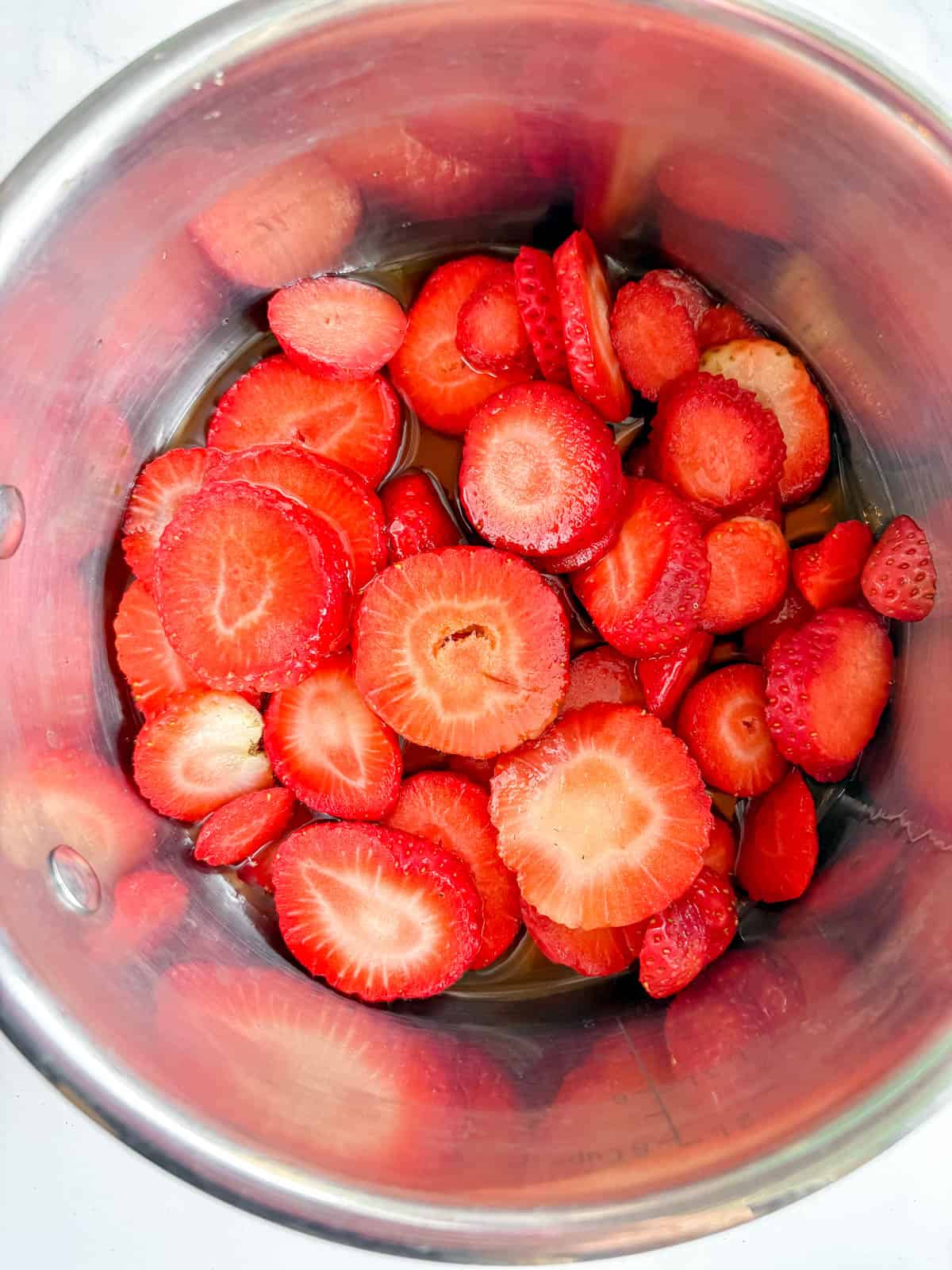 Sliced strawberries in a pot before cooking.