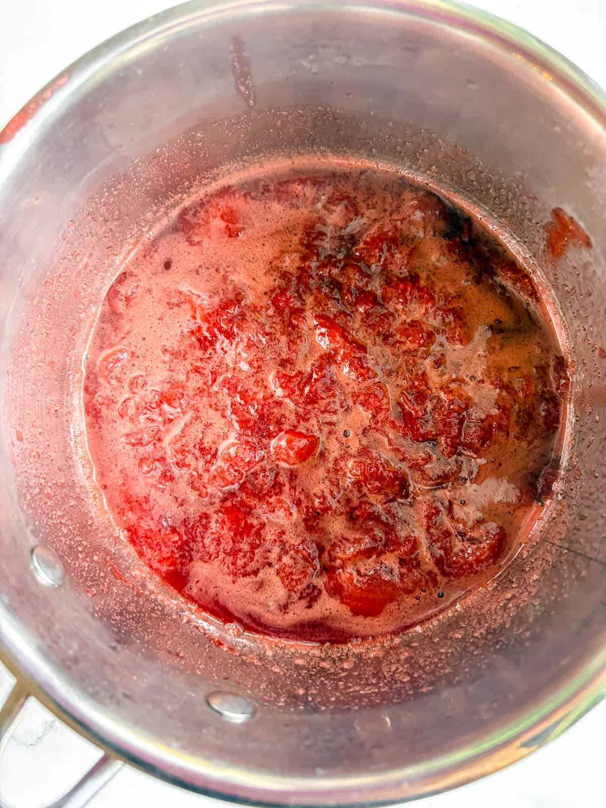 Strawberries cooked in a pot.