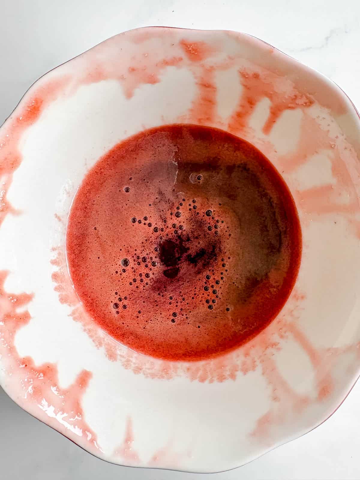 Strawberry syrup in a bowl.