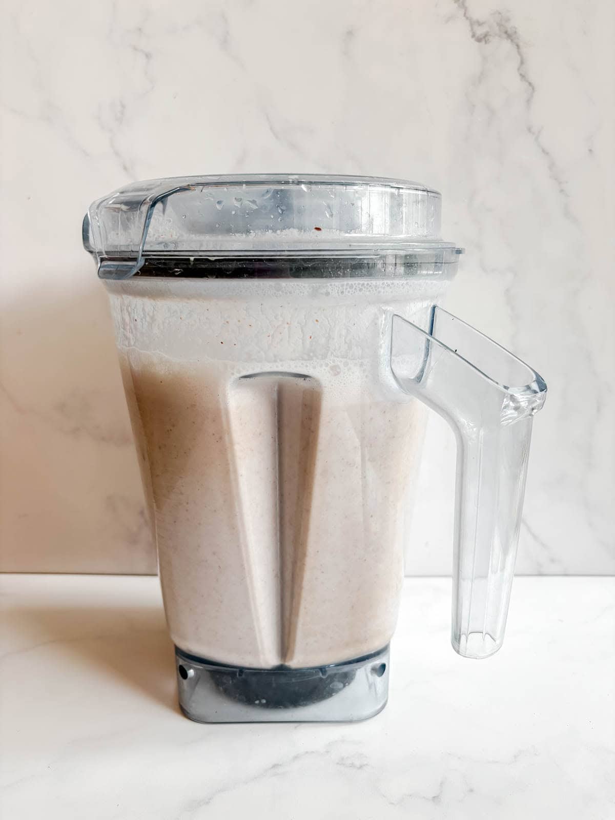 Almonds mixed into water in a blender.