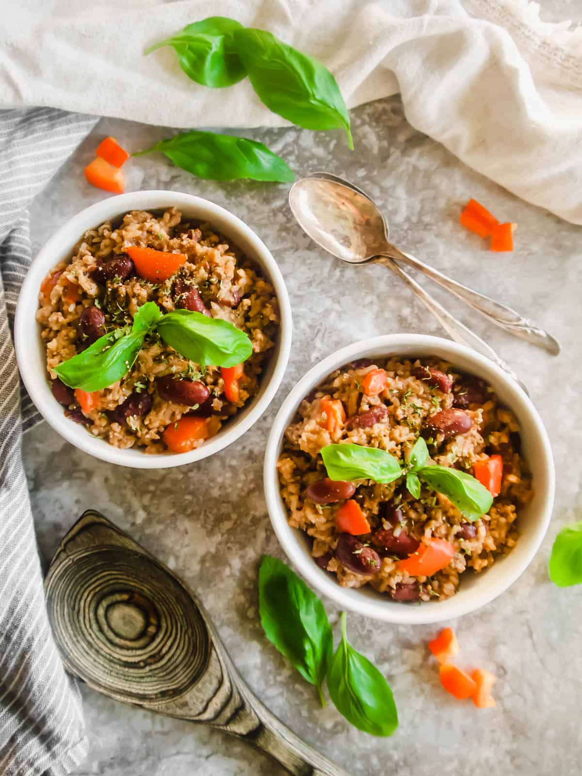 Two bowls full of turkey rice and beans.