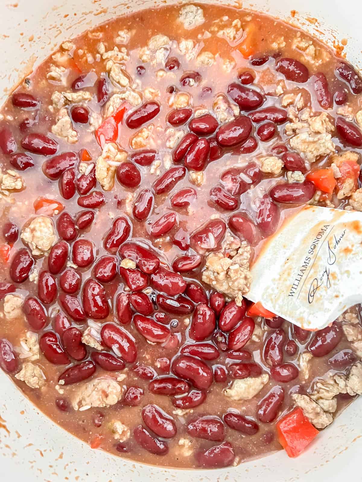 Chicken stock, rice and beans added to the turkey in the pot.