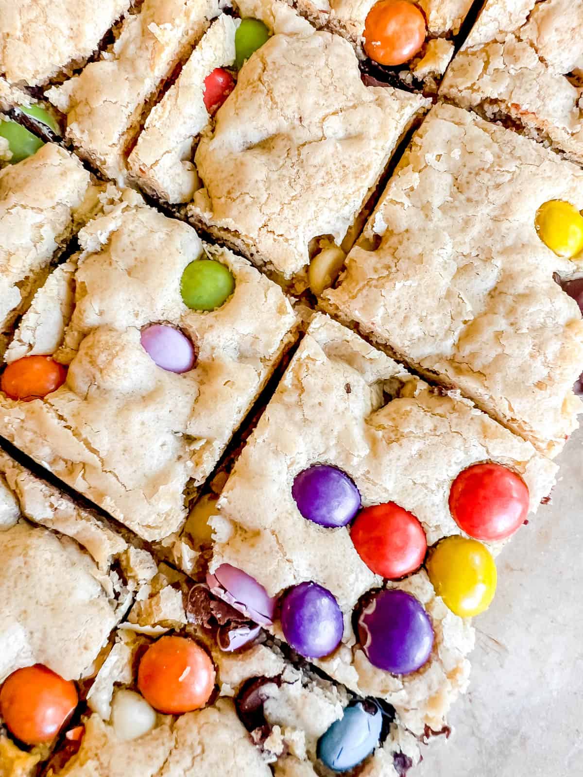 Gooey chocolate chip cookie bars with chocolate candies inside.