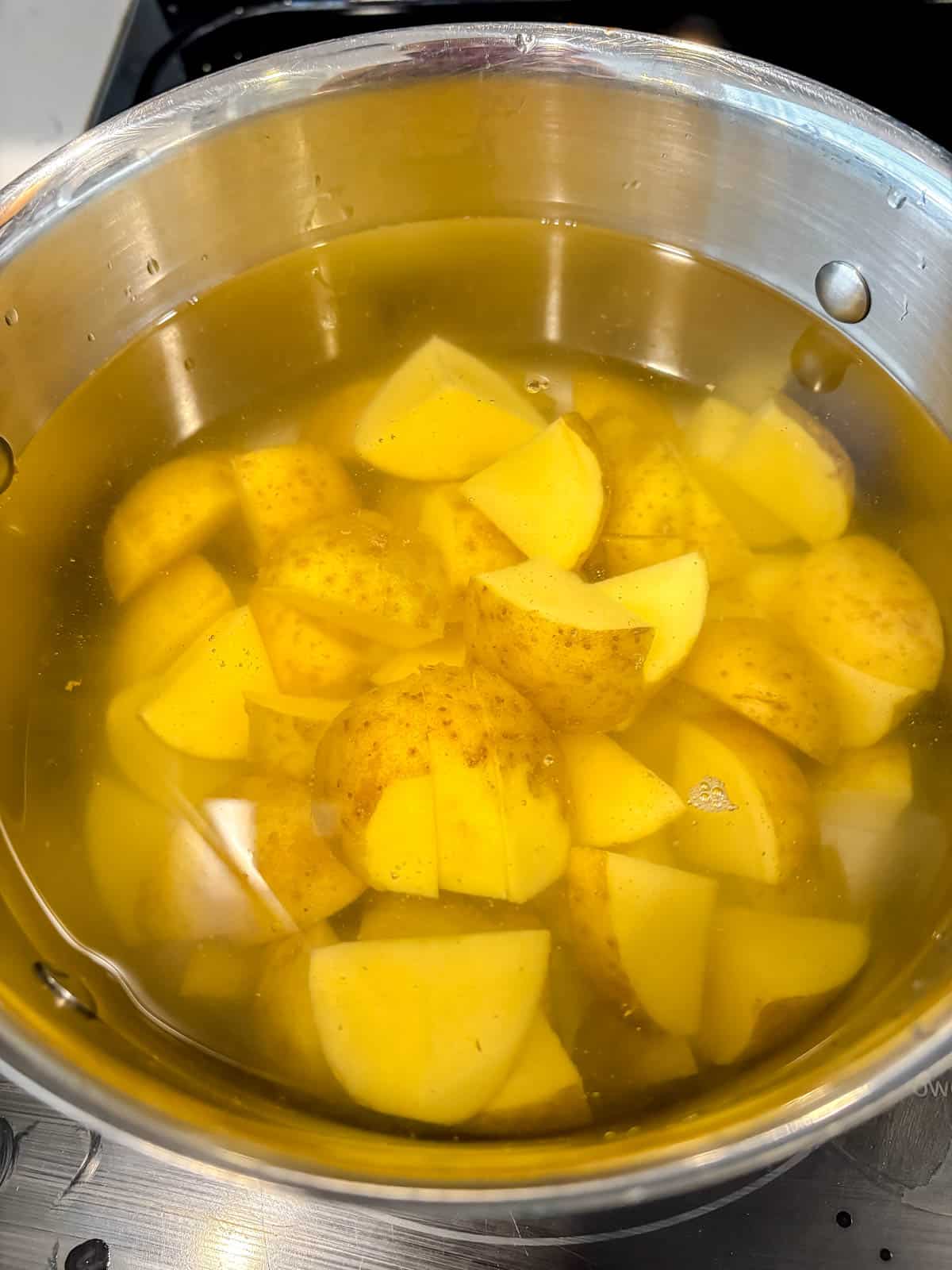 Potatoes boiling in a pot.