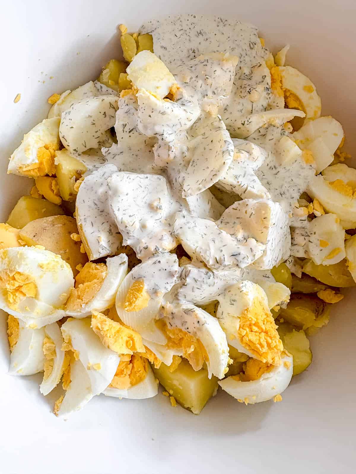 All parts of the potato salad in a bowl before getting mixed.