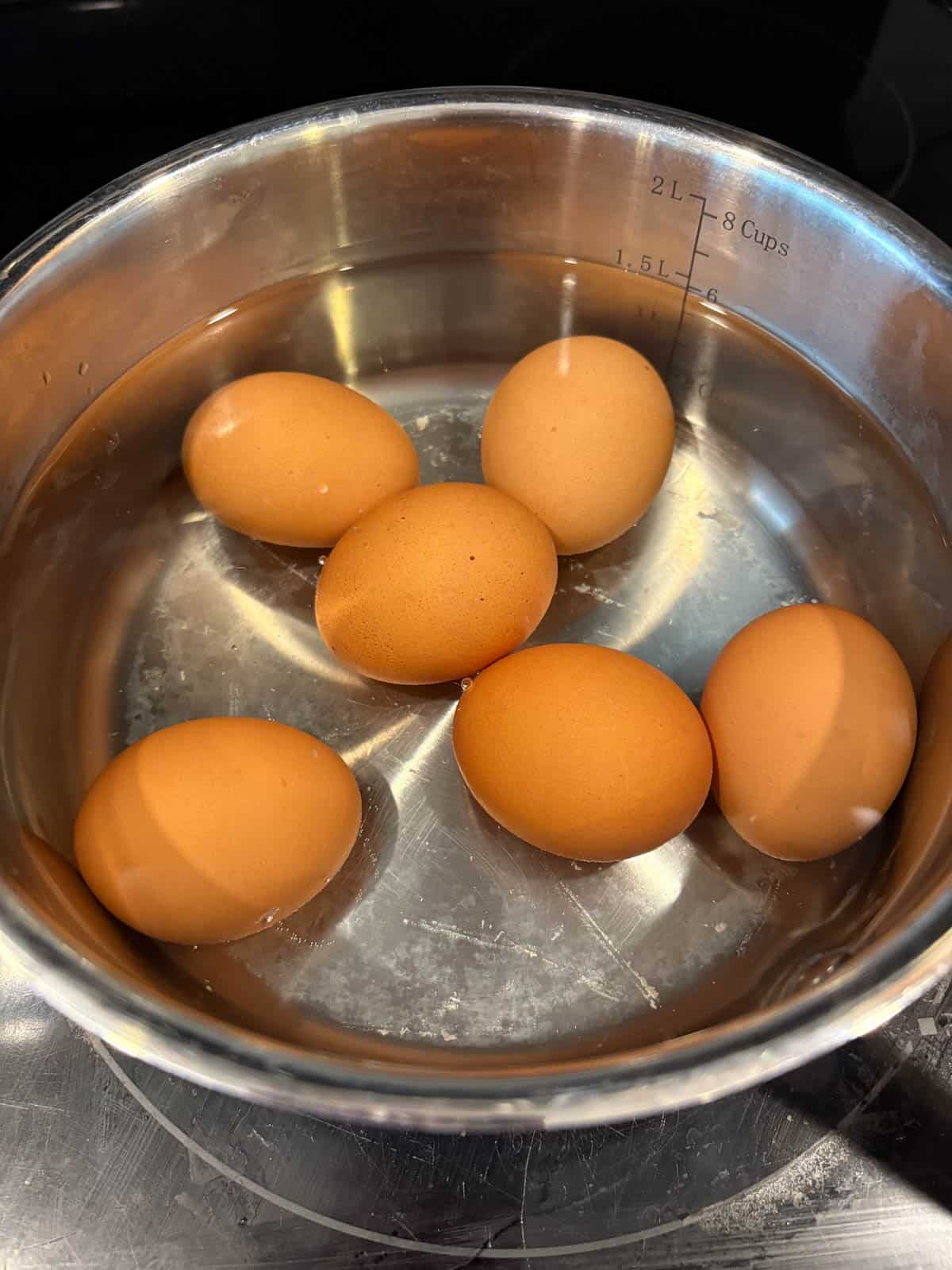 Eggs boiling in a pan.