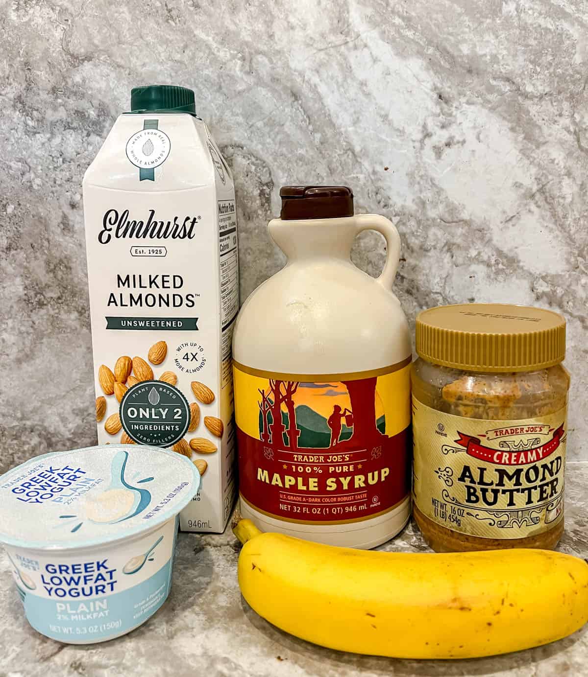 Ingredients needed to make a banana yogurt smoothie with maple syrup.