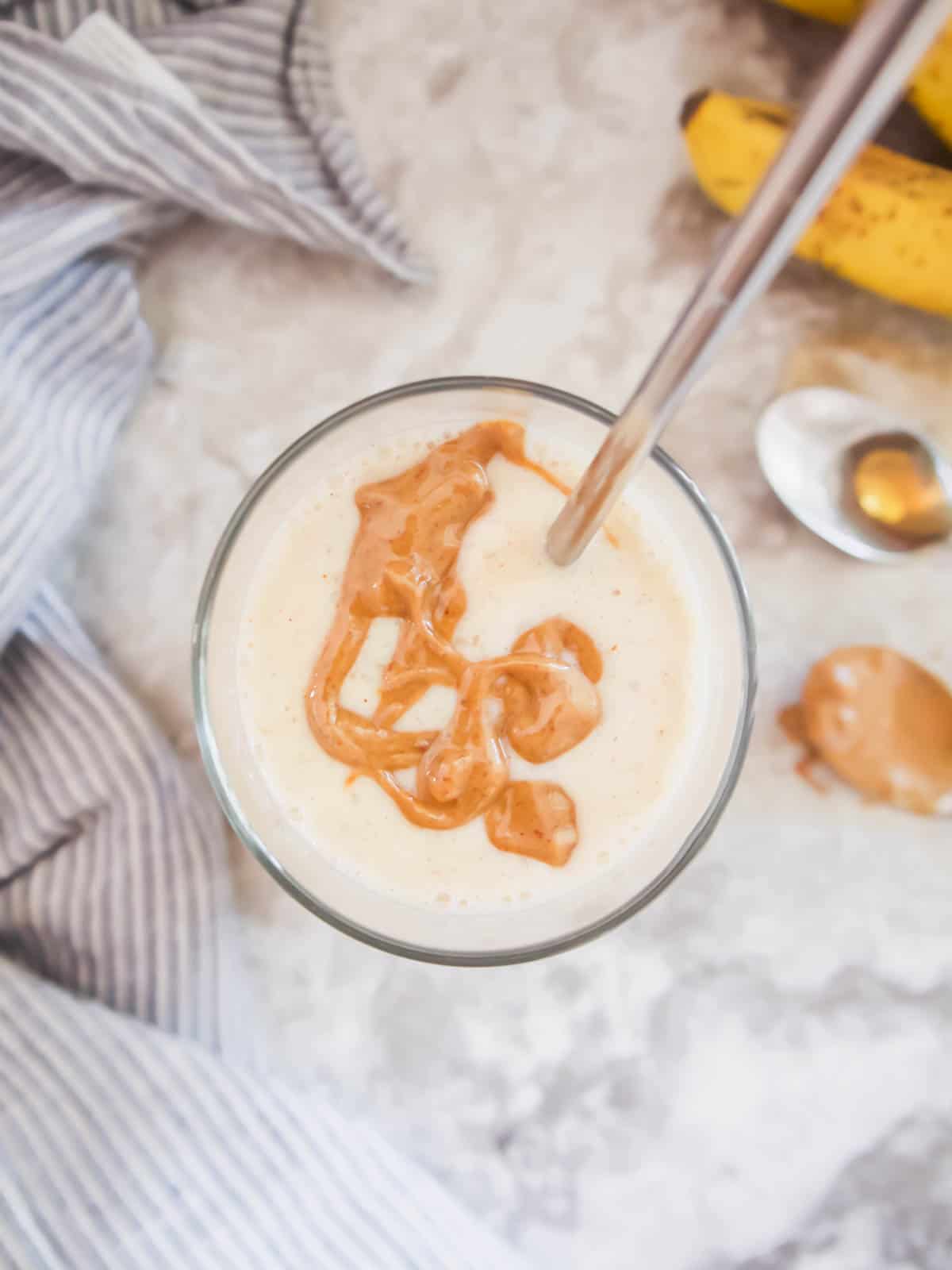 Maple syrup smoothie with almond butter drizzled on top.