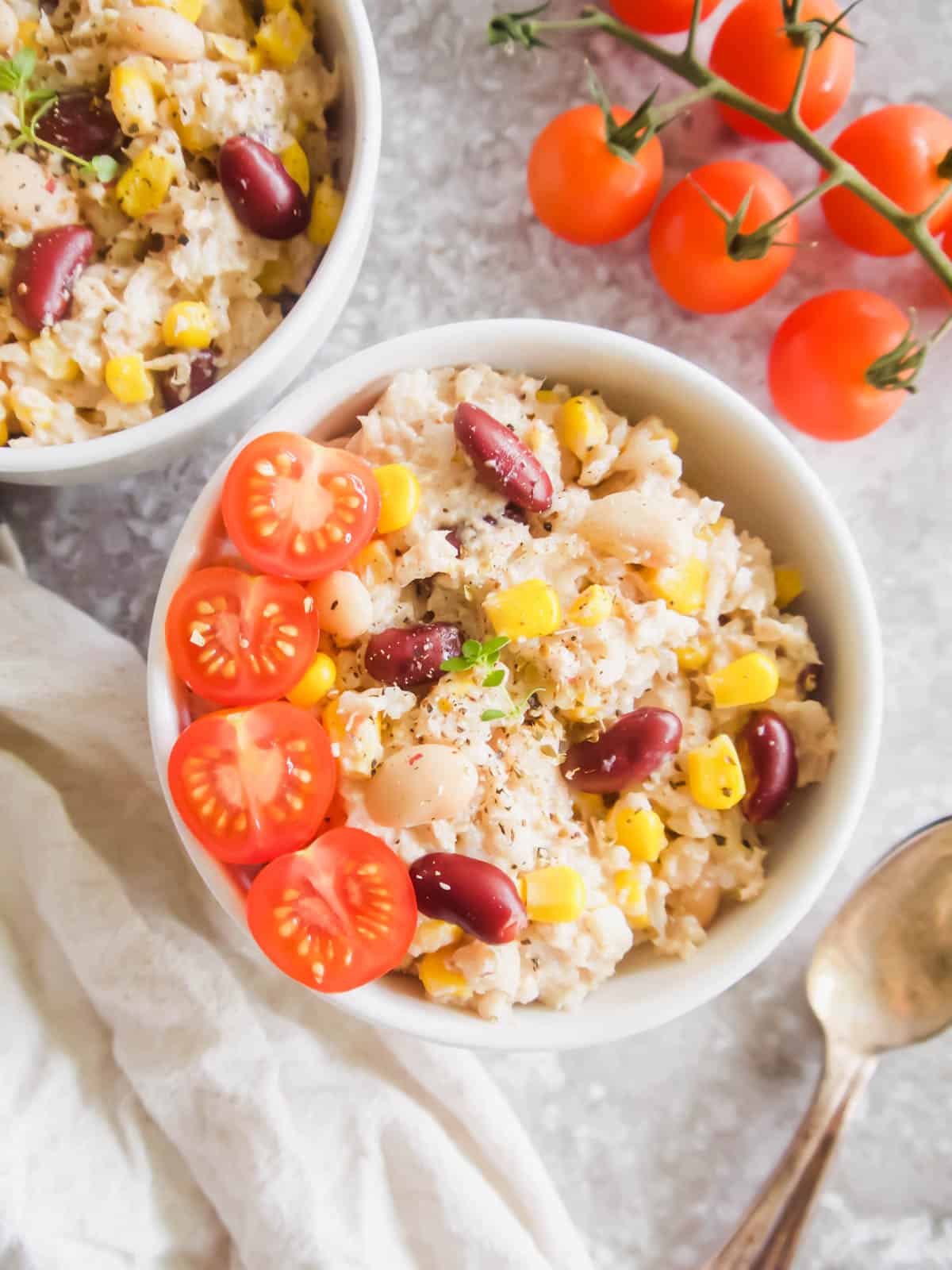 Finished tuna rice salad in a bowl with tomatoes added.