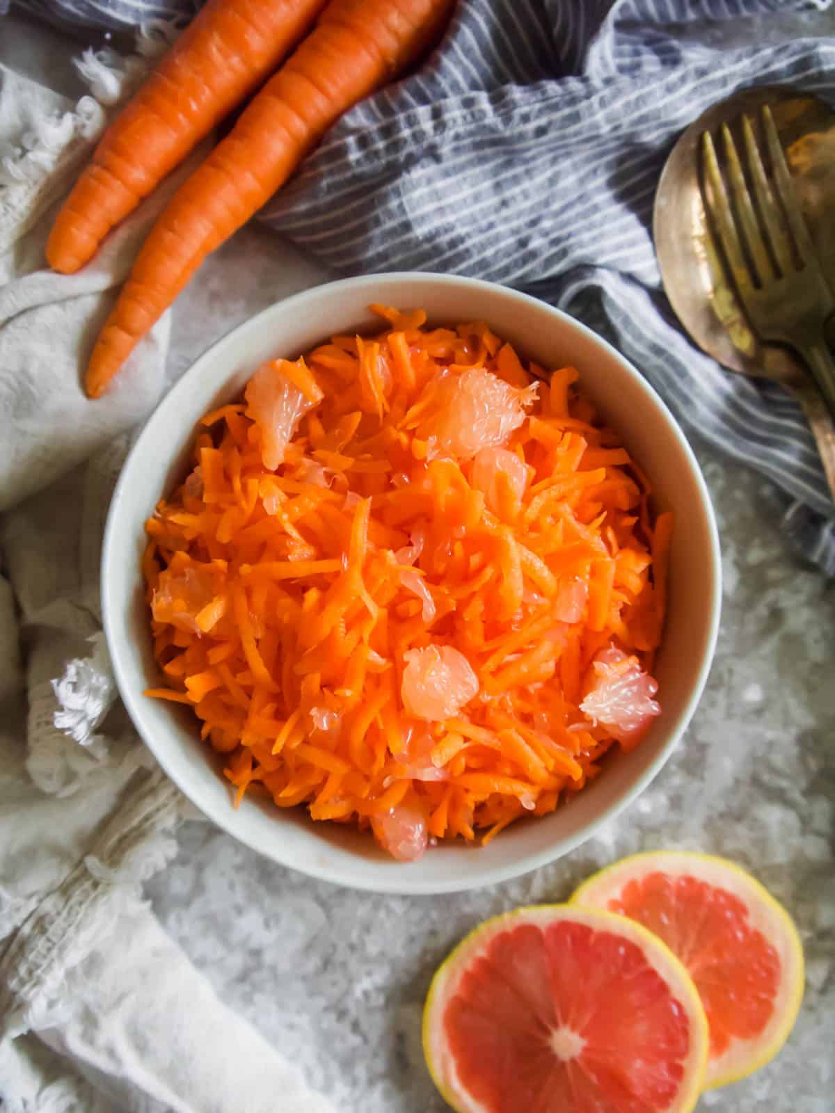 Raw Shredded carrot in a bowl, aerial view.