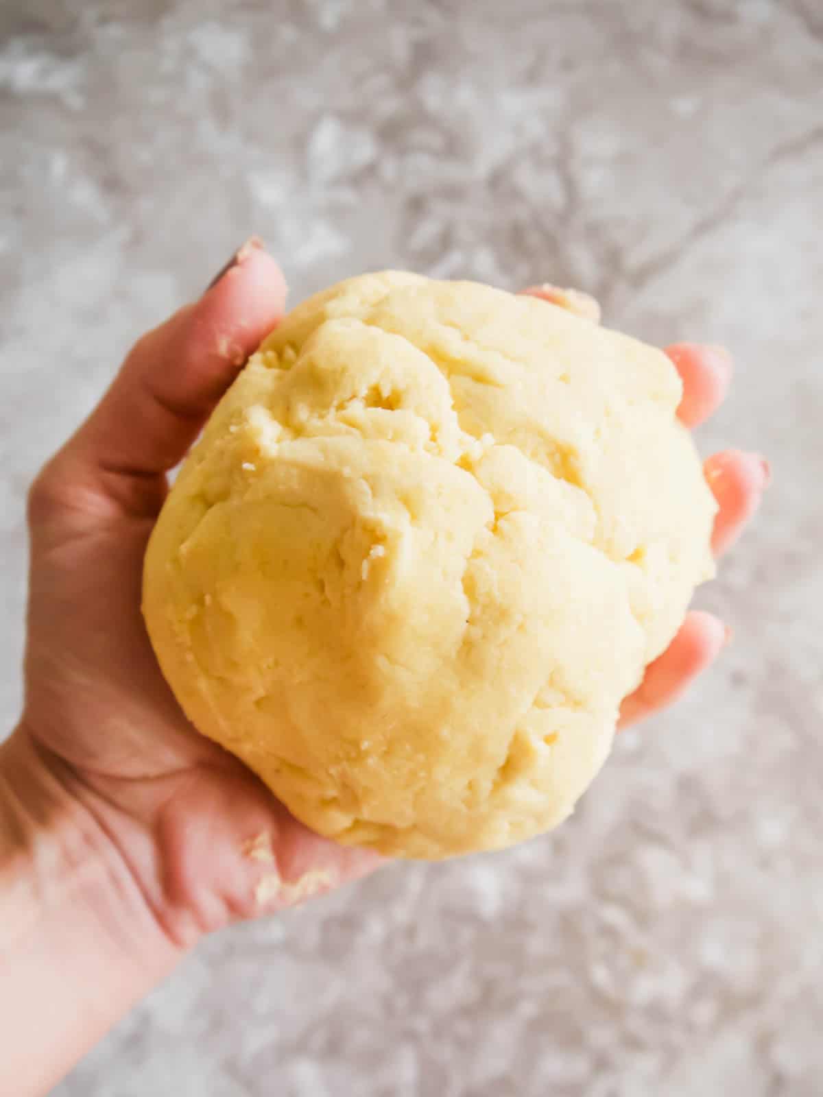Gluten-free pie crust in ones hands.