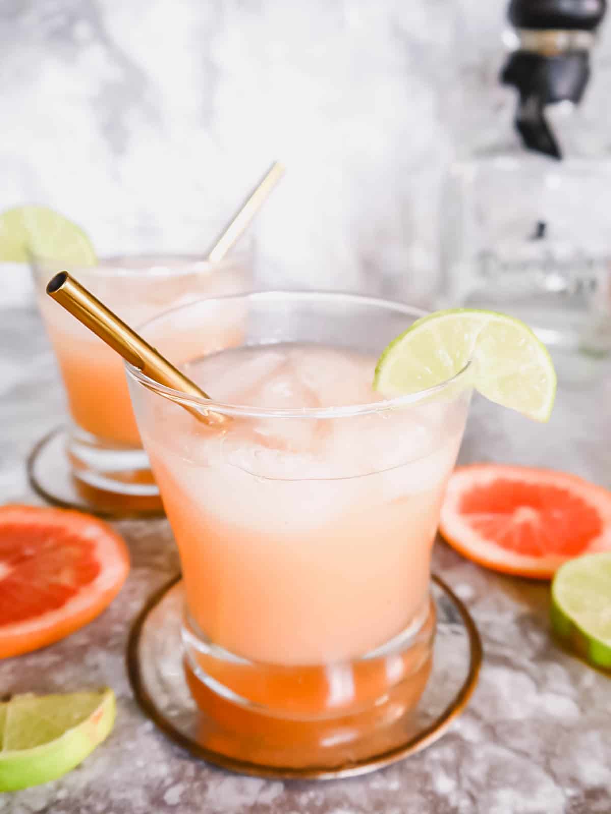 Fresh paloma recipe in two glasses with straws.