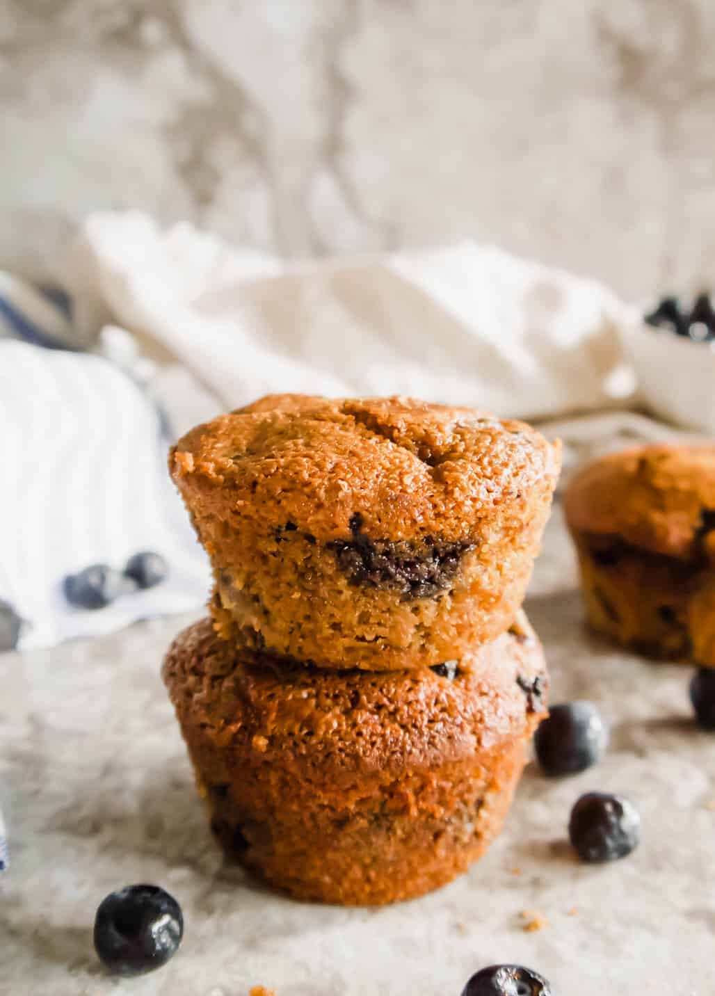 Paleo blueberry muffins on top of each other.