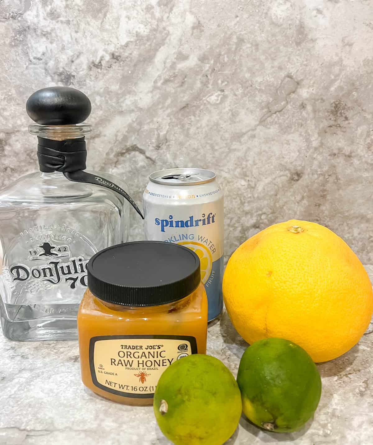 Ingredients needed to make a homemade paloma cocktail.