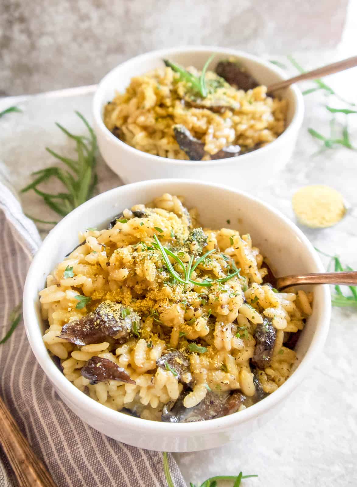 Risotto with nutritional yeast on top in a bowl.