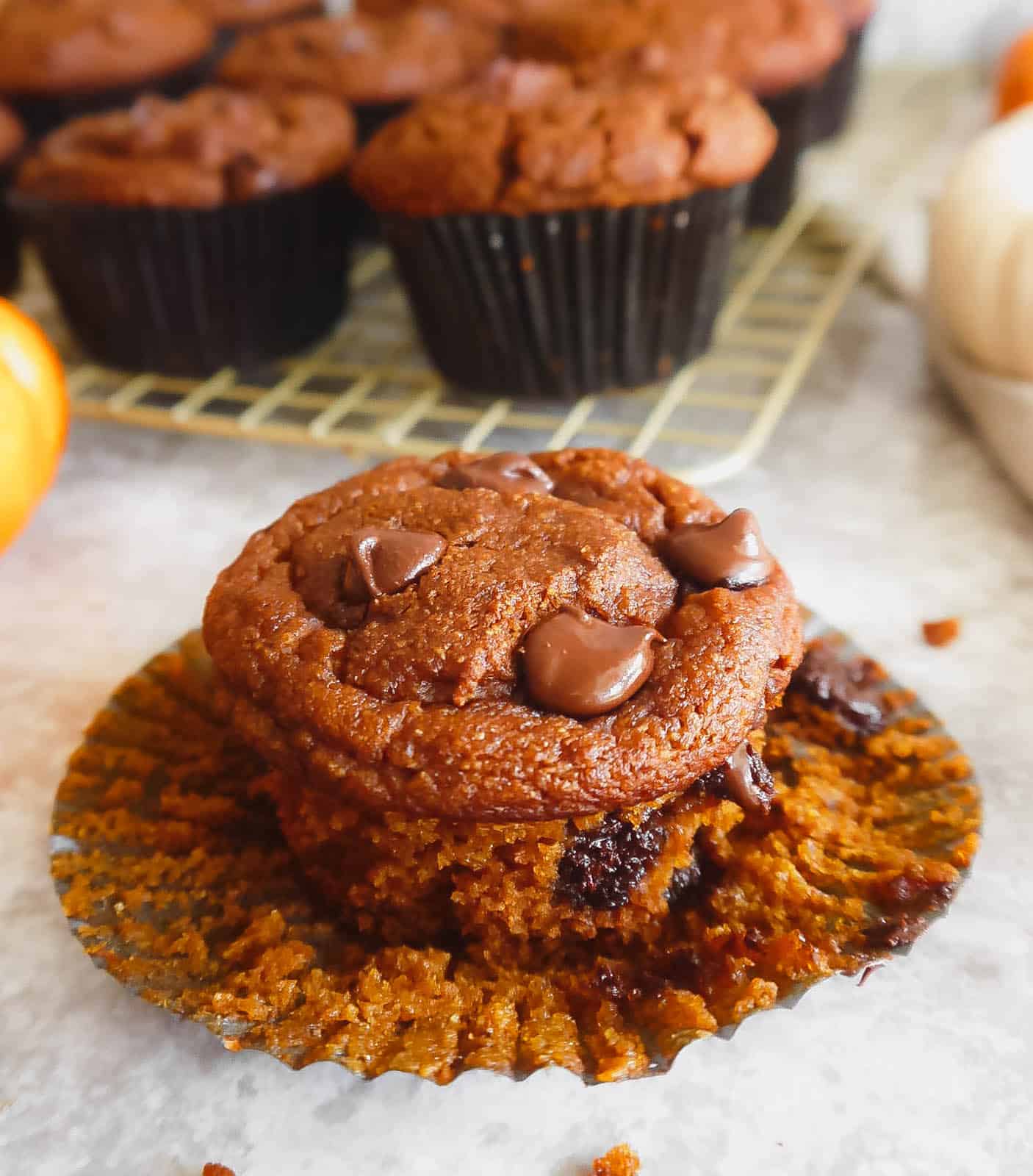 Paleo pumpkin muffins with melted chocolate chips on top.