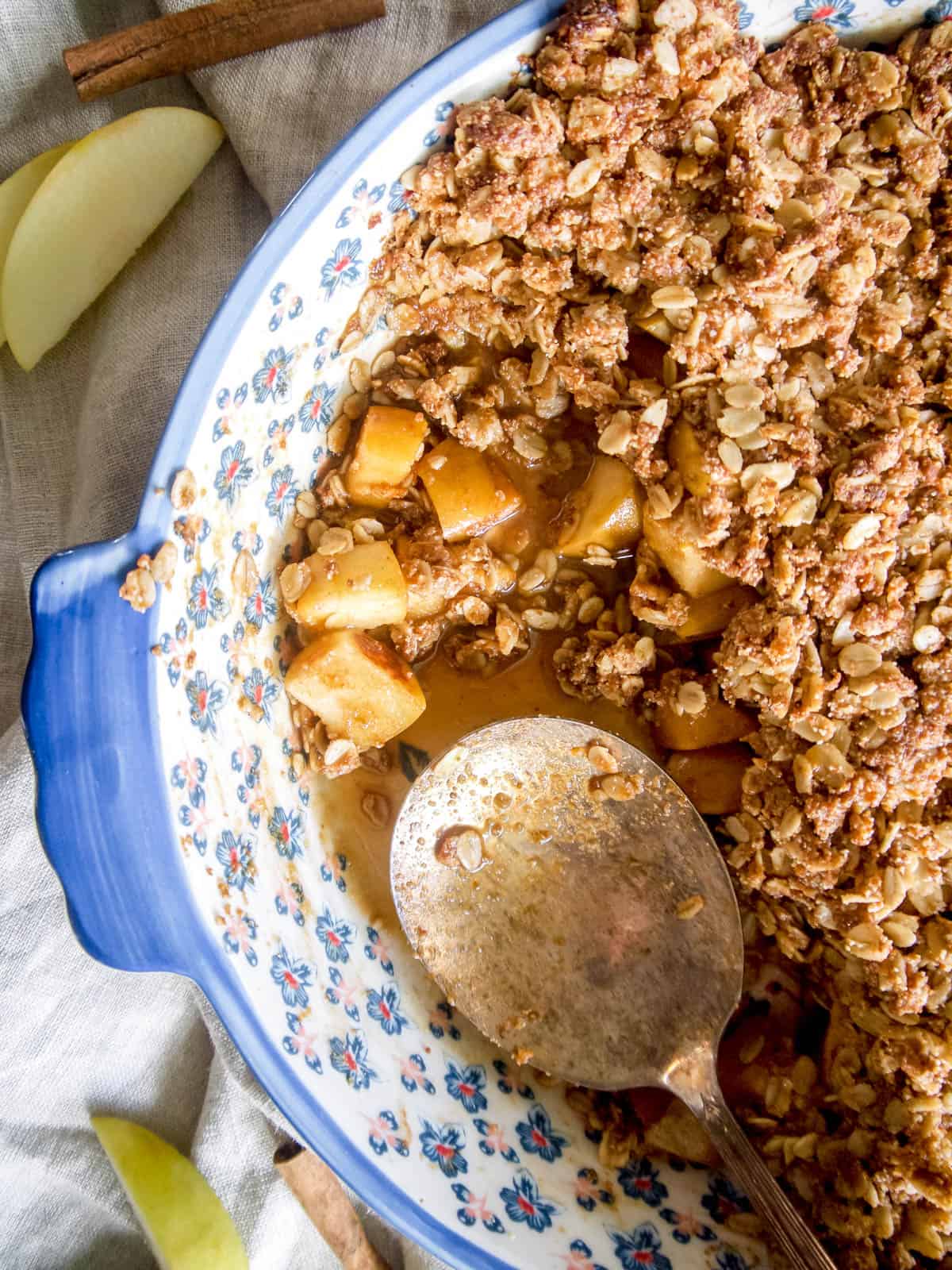 Finished vegan apple crisp with a spoon in the dish.