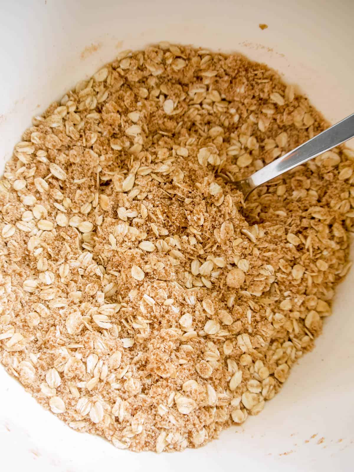 Almond and oat crisp topping mixed together in a bowl.
