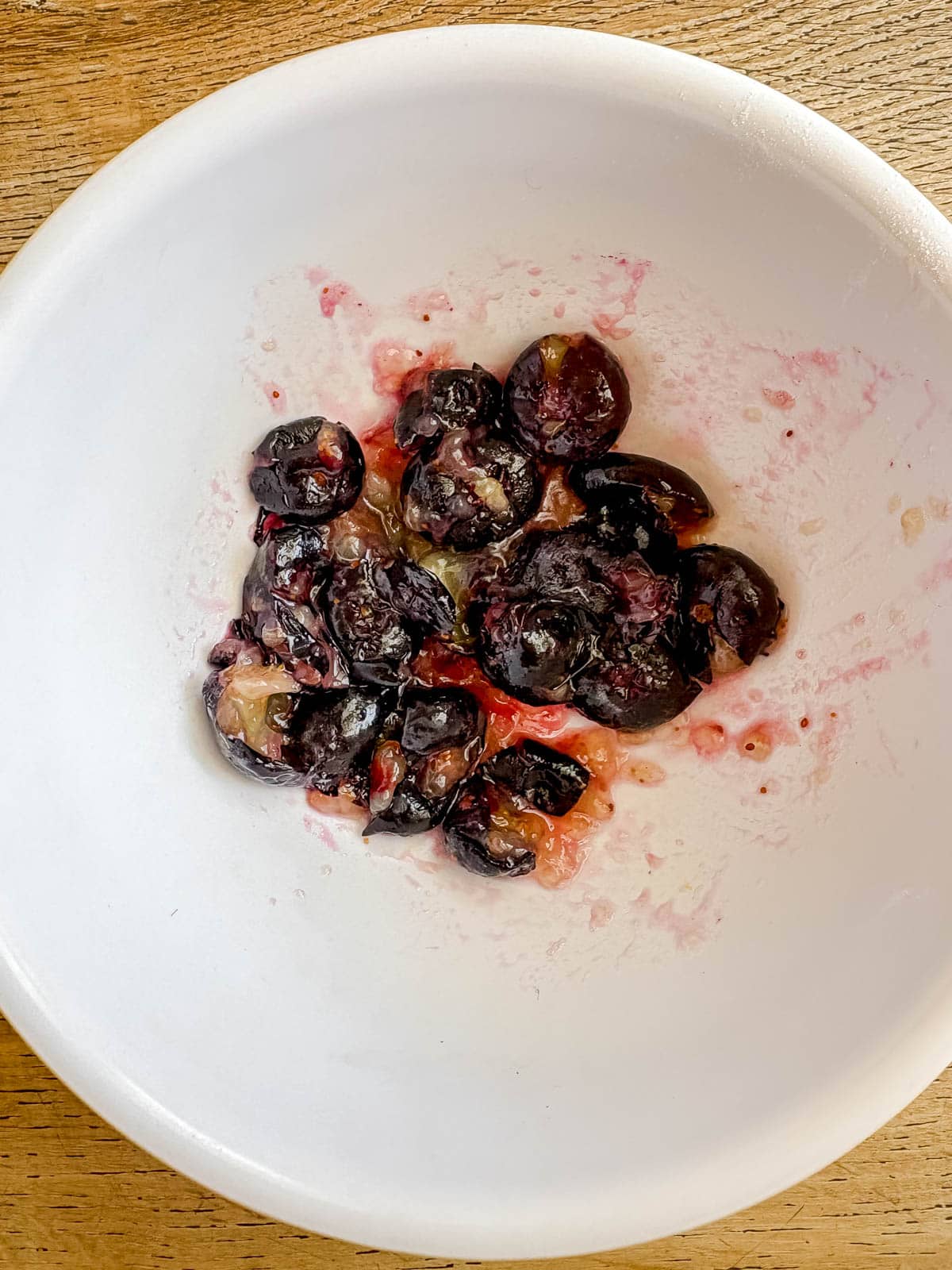 Mashed blueberries in a bowl.