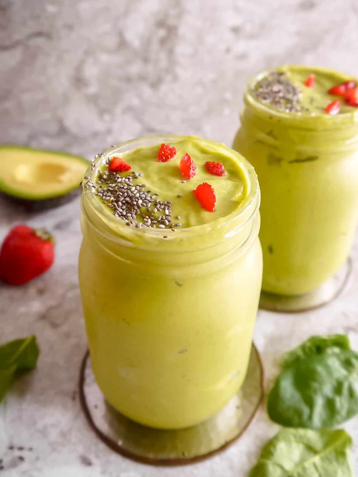 Avocado and strawberry smoothie in two cups.