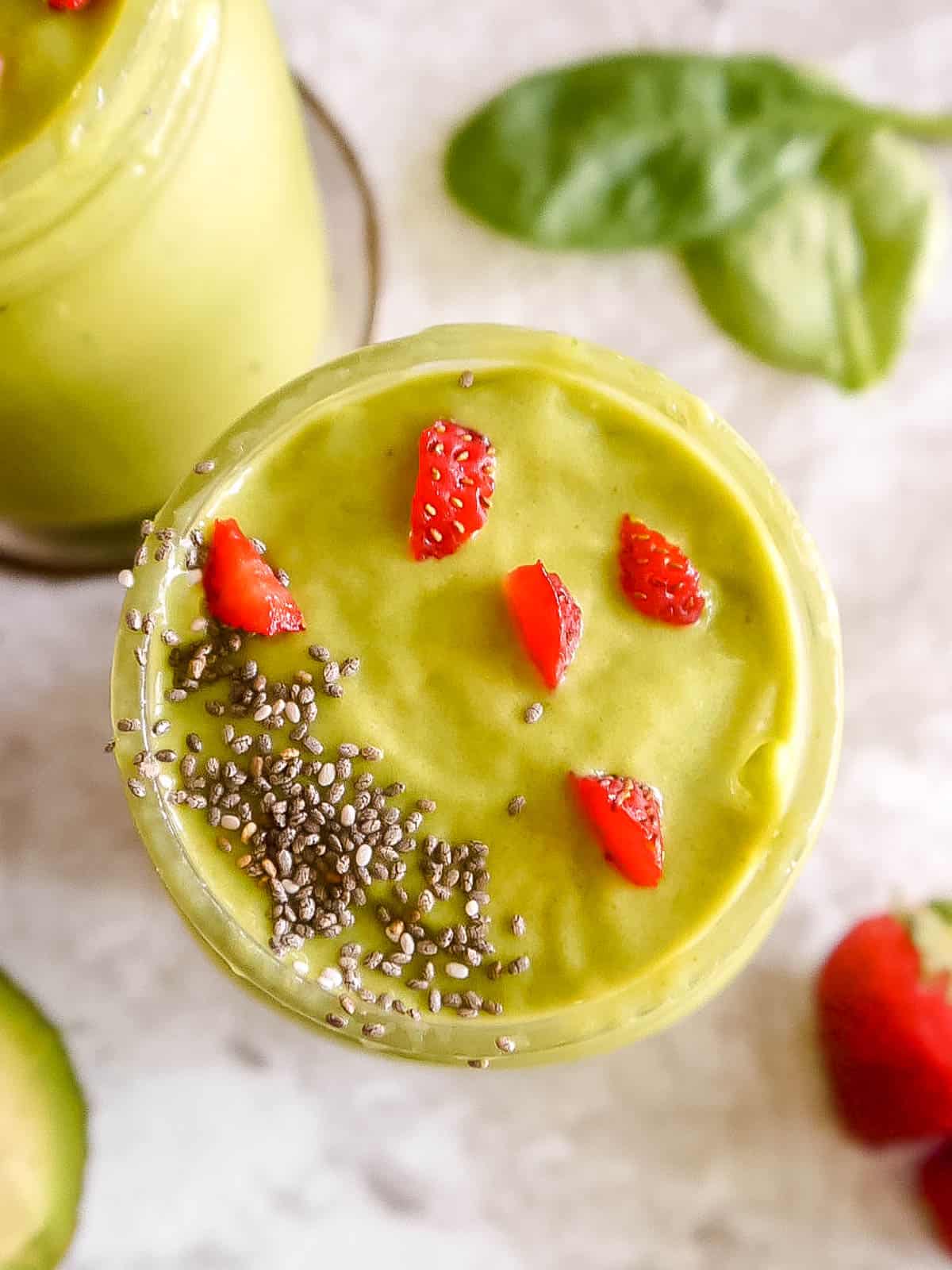 Strawberry spinach smoothie with chia seeds on top.