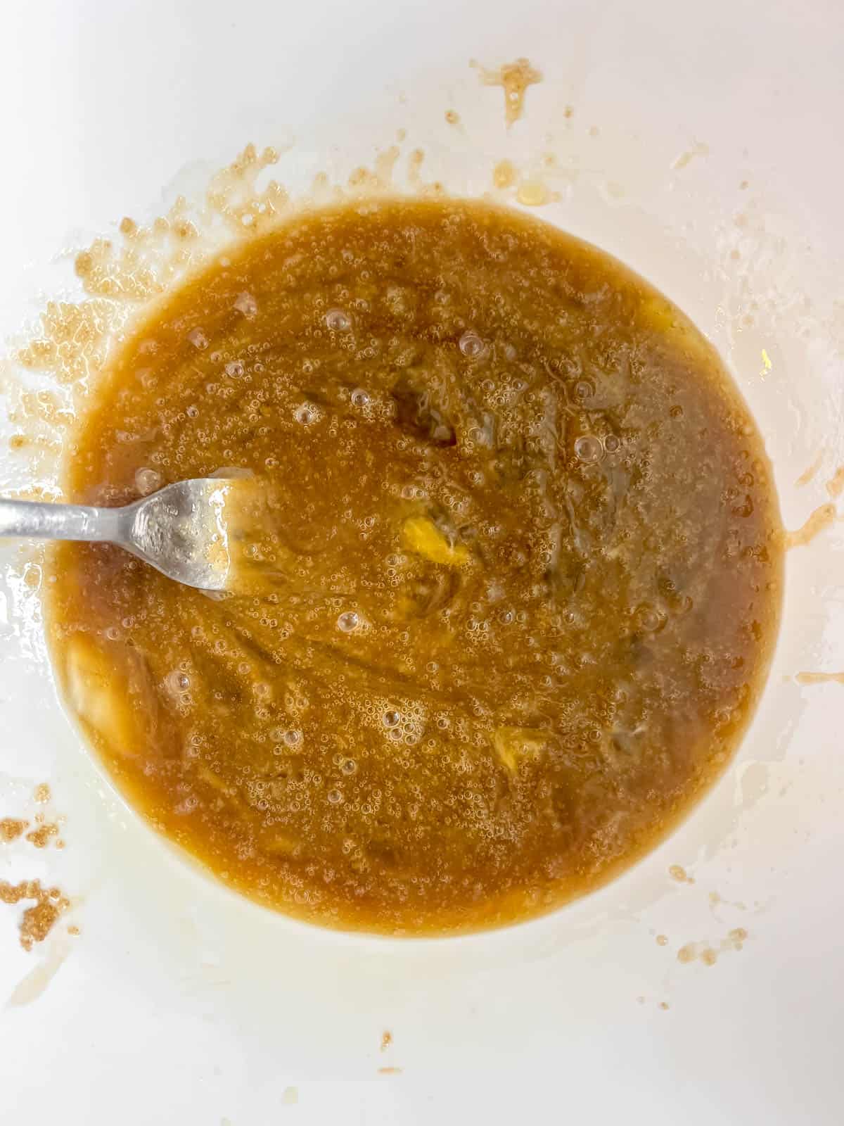 Wet sugar ingredients in a bowl.