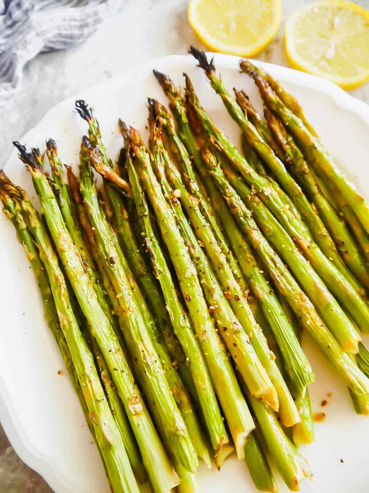 Asparagus with lemon freshly broiled and put on a plate.