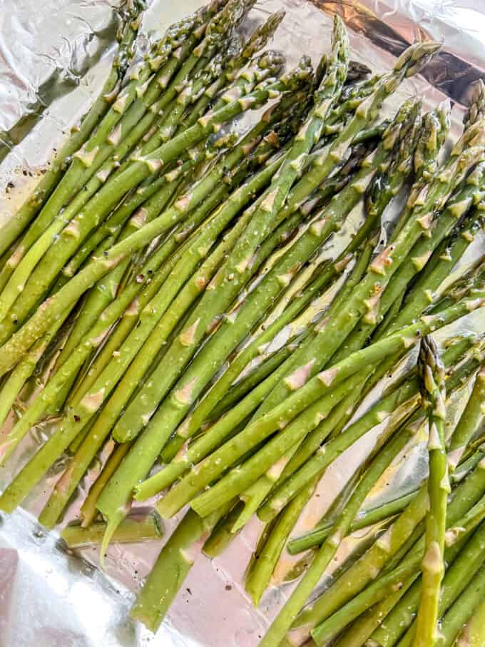 Uncooked asparagus on a pan.