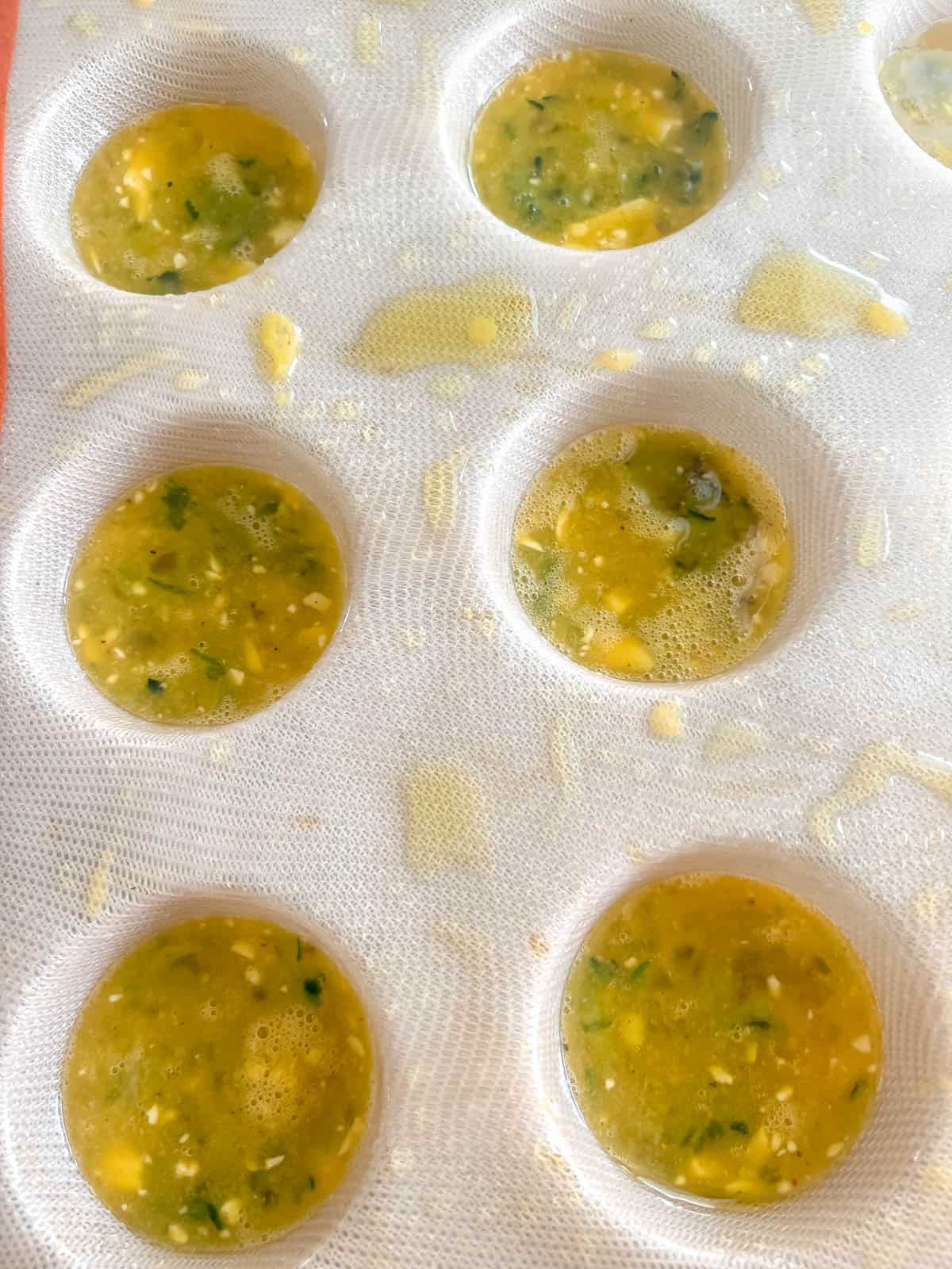 Egg mixture in silicone muffin tin.