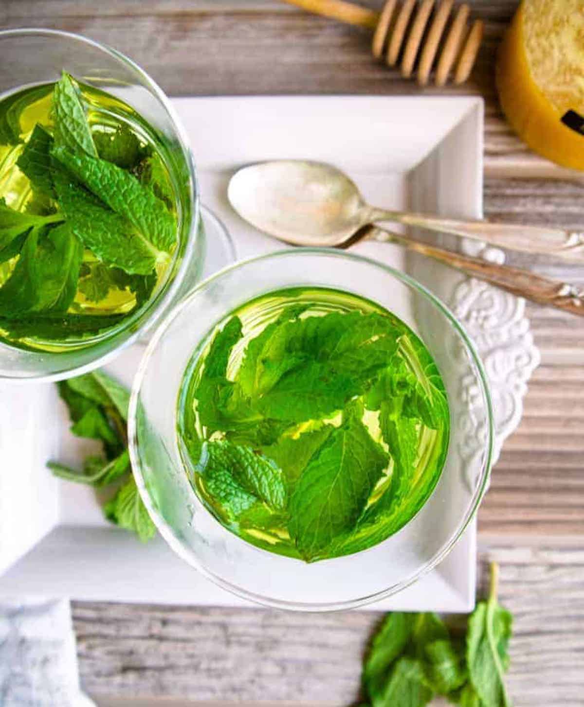 Aerial view of two cups of fresh mint tea.