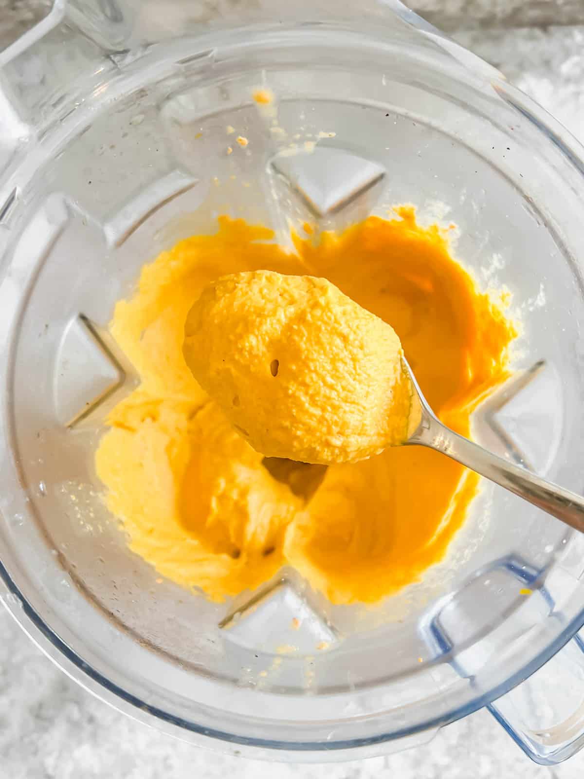 Spoonful of carrot hummus straight out of the blender.