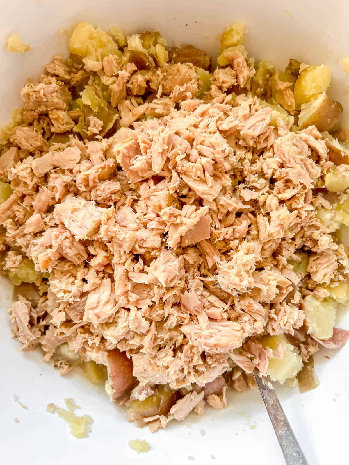 Tuna and potatoes in a large bowl.