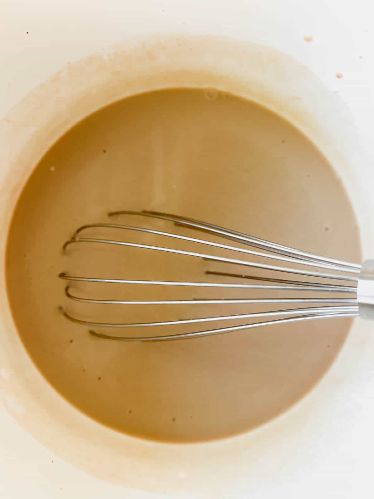 All the irish cream ingredients mixed together in a bowl.