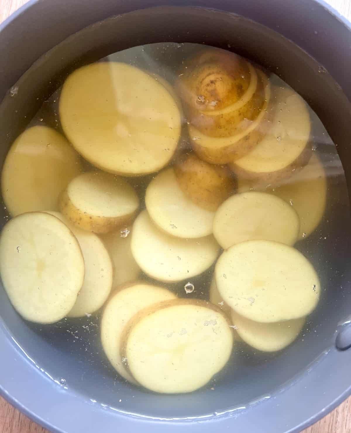 Potatoes in a pan with water before boiling.