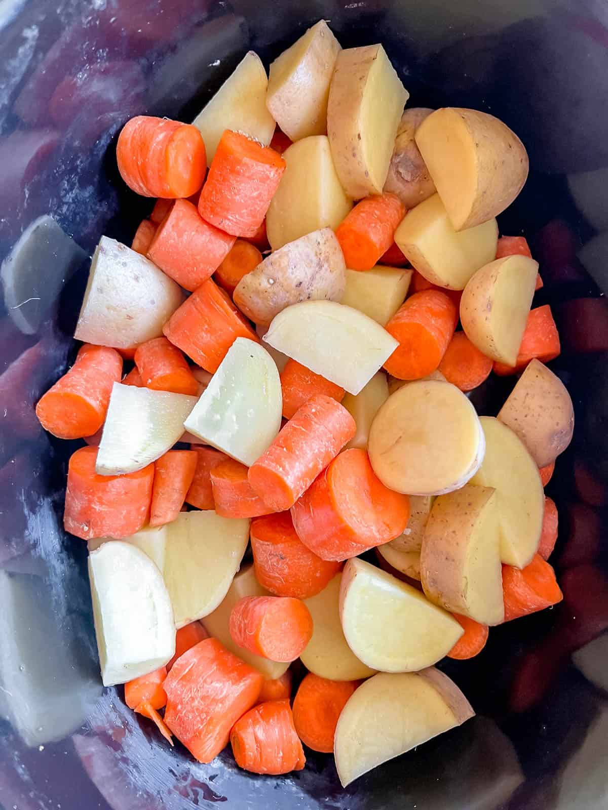 Carrot and potatoes in crock pot.