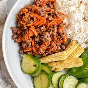 Korean beef bowl with rice, cucumbers, and corn.