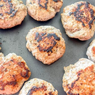 Turkey sausage patties in a pan after cooking.