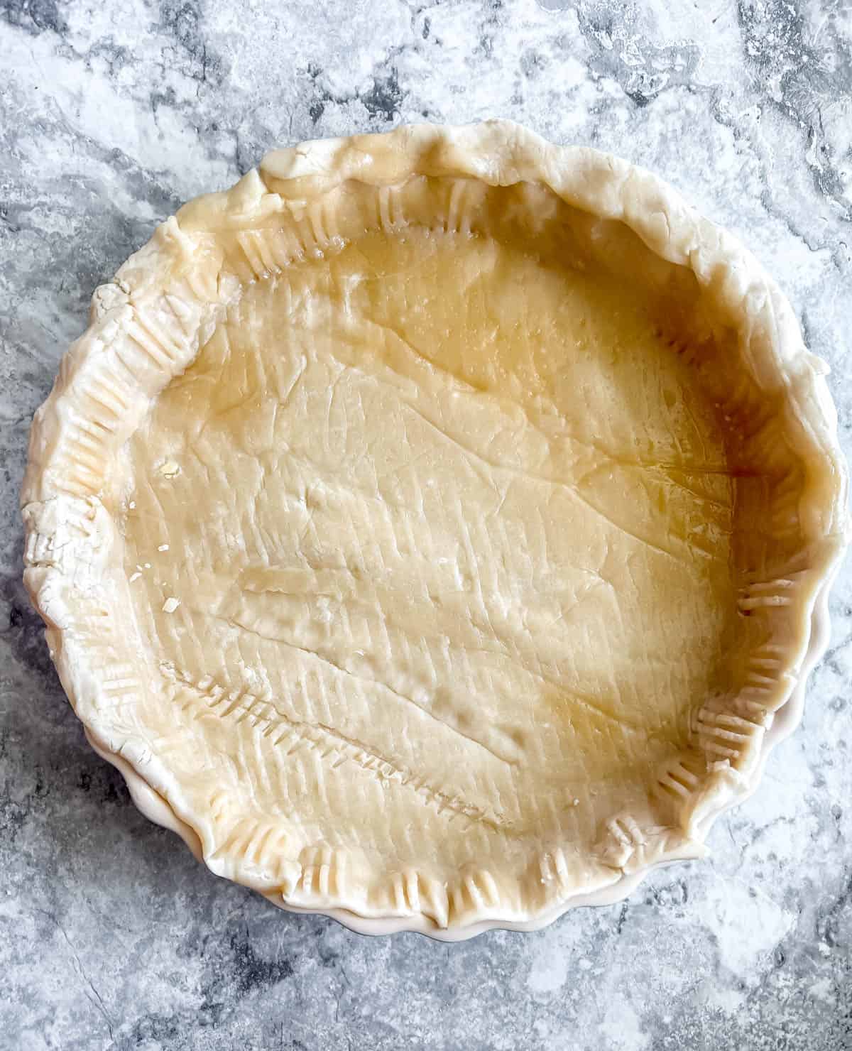 Store bought pie crust added to the pan.