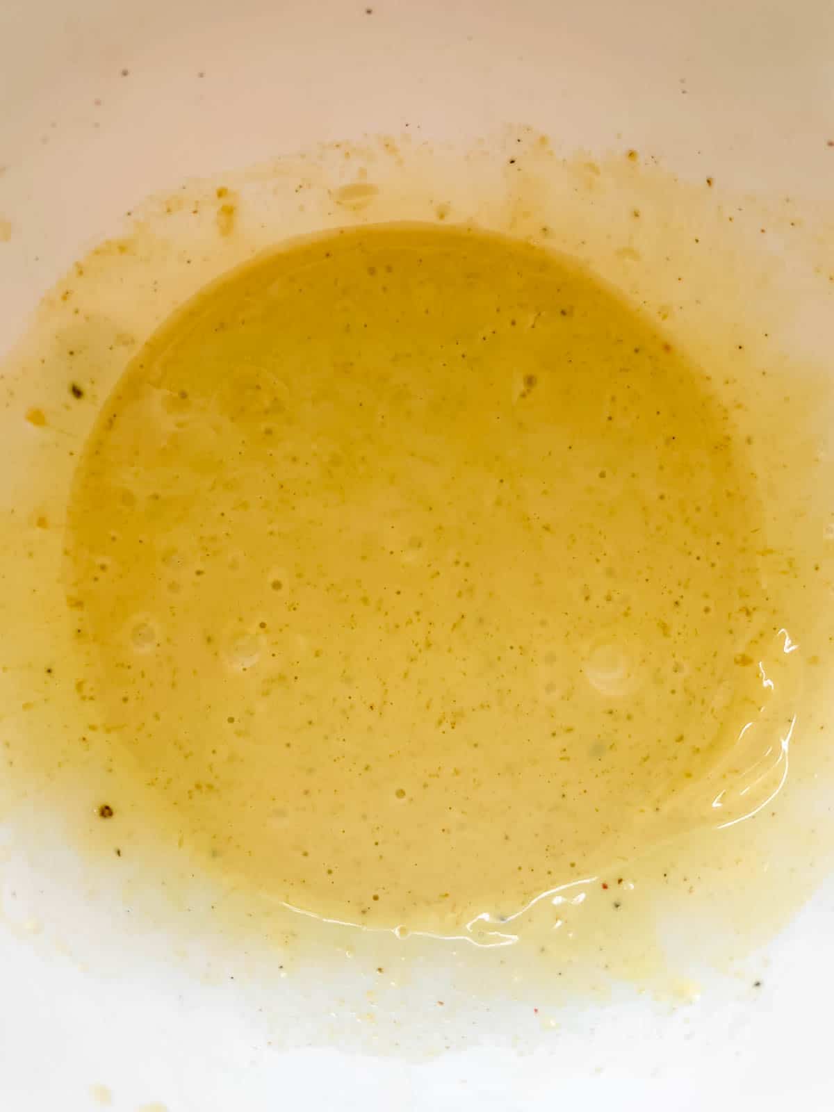 The dressing mixed together in a bowl.