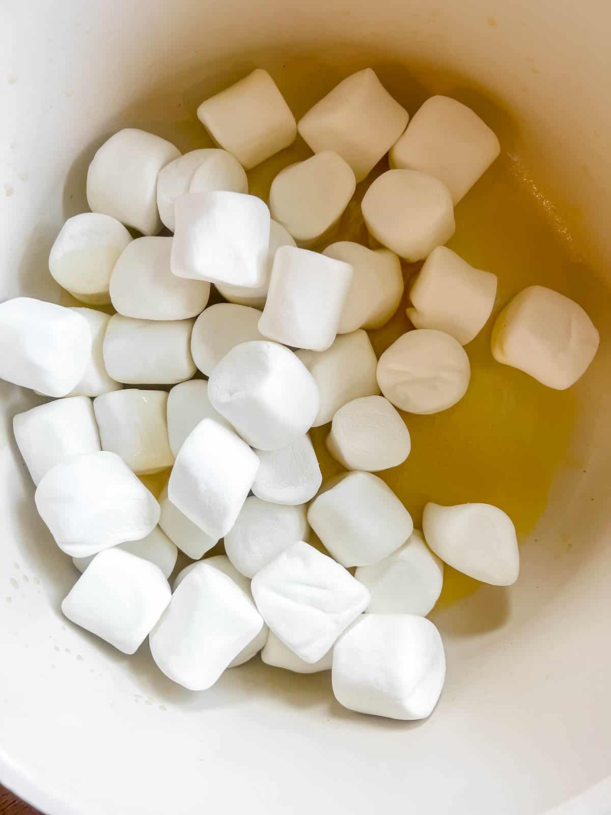 Marshmallows added to butter in a pan.