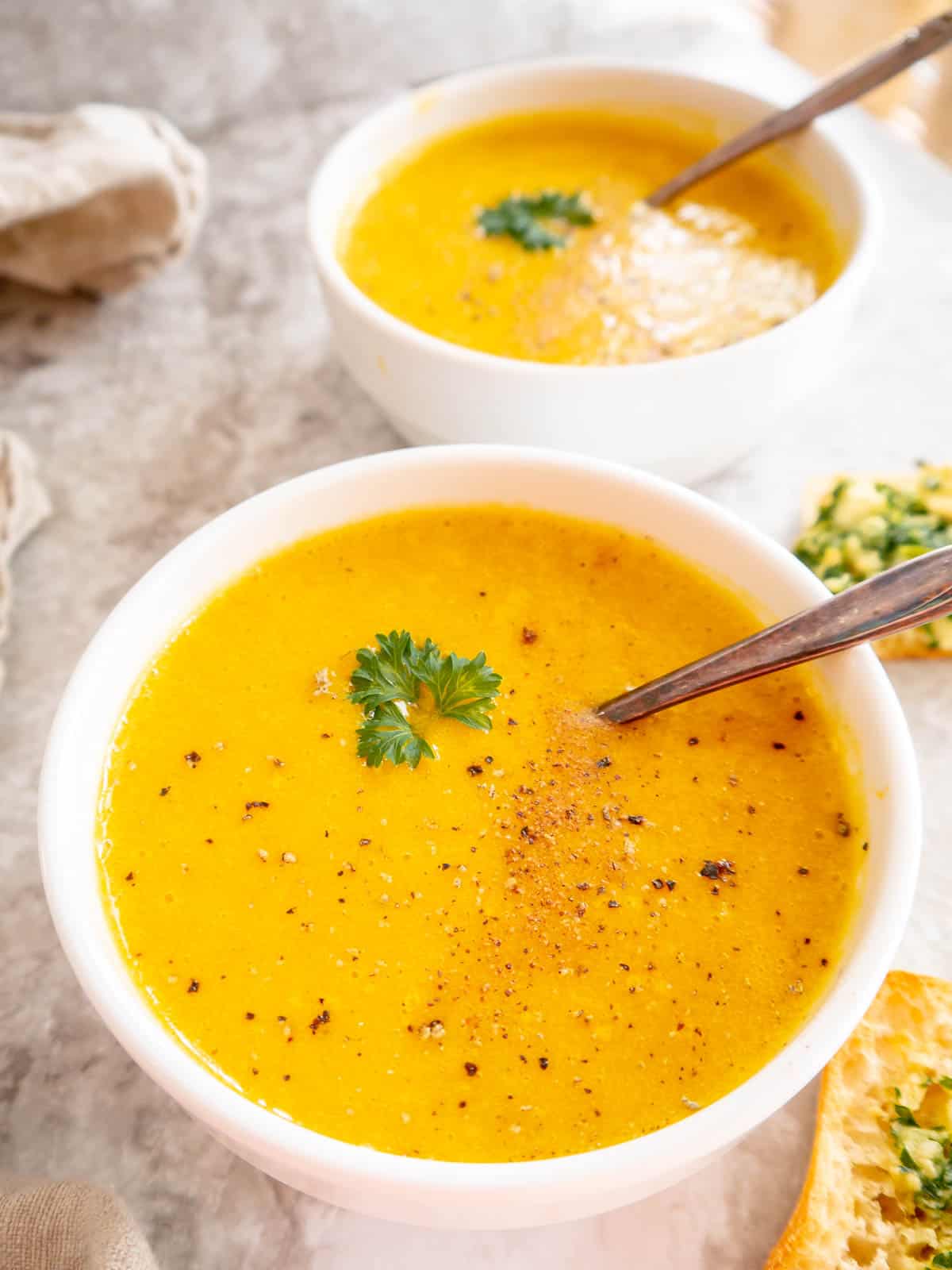High protein butternut squash soup in two bowls.