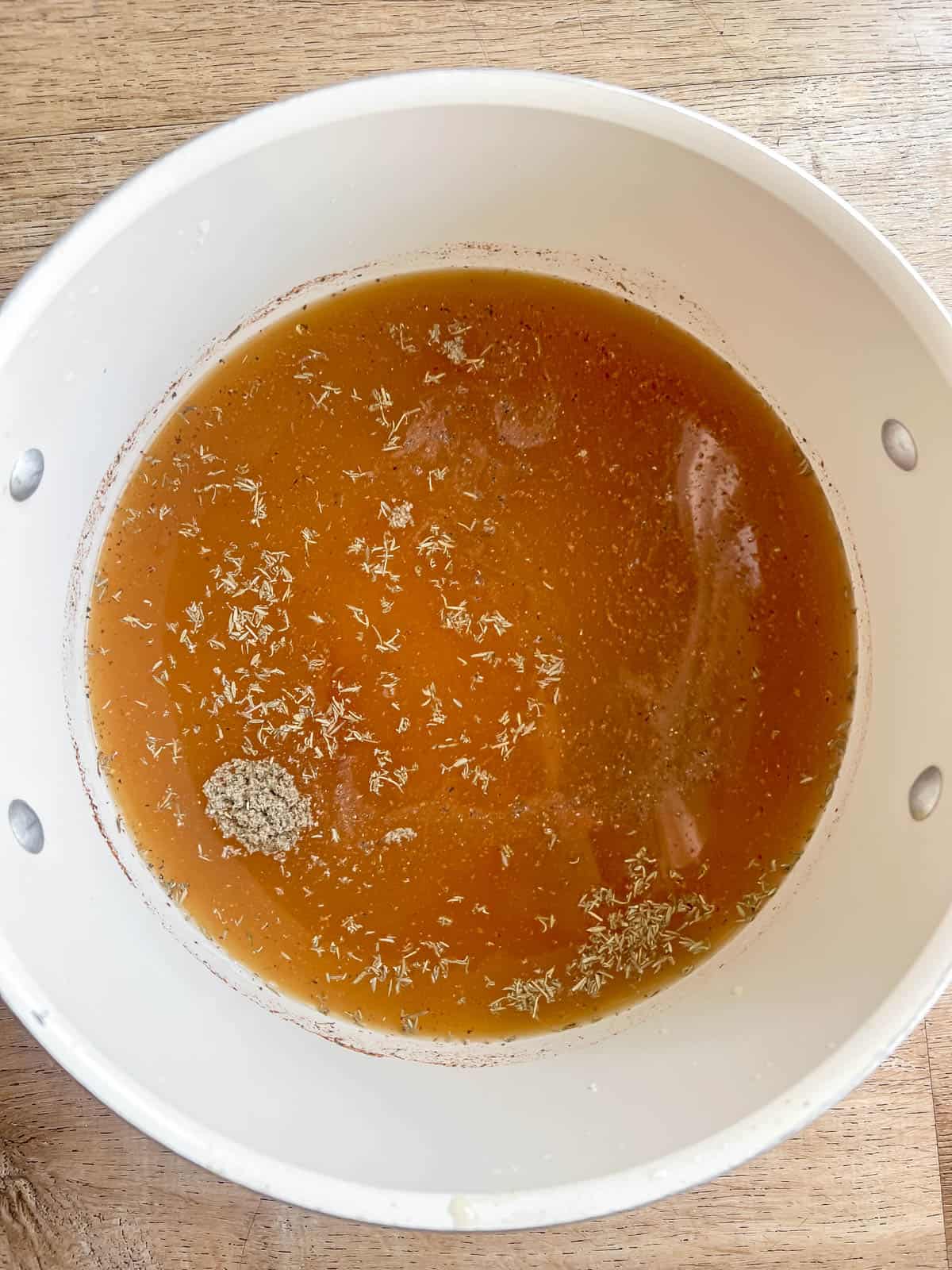 Bone broth in a soup pan.